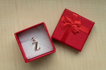 Silver pendant in Z-shaped box.