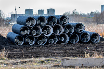 Industrial plastic tubing. Black PVC, PE pipes for underground drainage and sewer systems.
