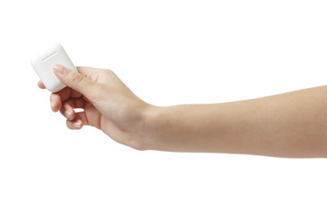 wireless headphones in a female hand isolated on white