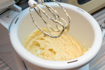 whipping with the mixer whisk raw dough for cupcake. Preparation cooking process
