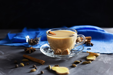 Flavoured masala Indian tea made by brewing black tea with milk, aromatic spices and herbs. Front view.