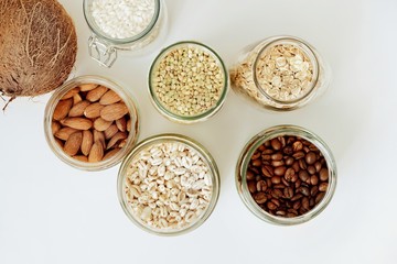 Various raw cereals, grains in glass jars. The concept of zero waste, food storage in the kitchen, healthy nutrition. View from above.