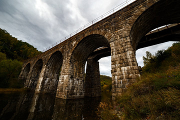 Fototapeta na wymiar Old stone bridge at Transsiberian railway at Baikal lake