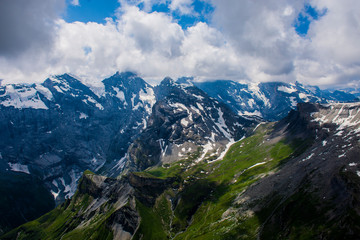 Fototapeta na wymiar Mountains in schilthorn Swiss Alps crossed by a cloud