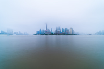 Fototapeta na wymiar The modern buildings of Lujiazui and Huangpu river with sunrise glow in Shanghai, China.