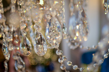 Crystals of a crystal chandelier with glow and refraction of light. Multi-colored glare on...