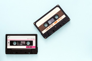 Two vintage audio tapes on a light blue background close-up. Top view