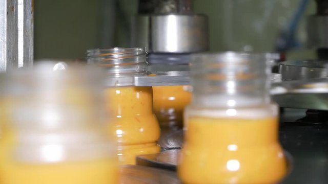Bottles capper putting caps on sauce bottles