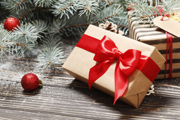 Composition from Christmas tree, gifts on a brown wooden background. Top view. Place for text.