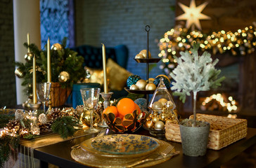 A large table is decorated for the festive dinner and Christmas. Christmas, a big star glows...