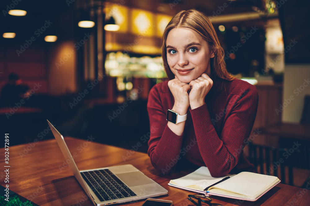 Poster happy female student looking at camera after planning time for course work in textbook, portrait of 