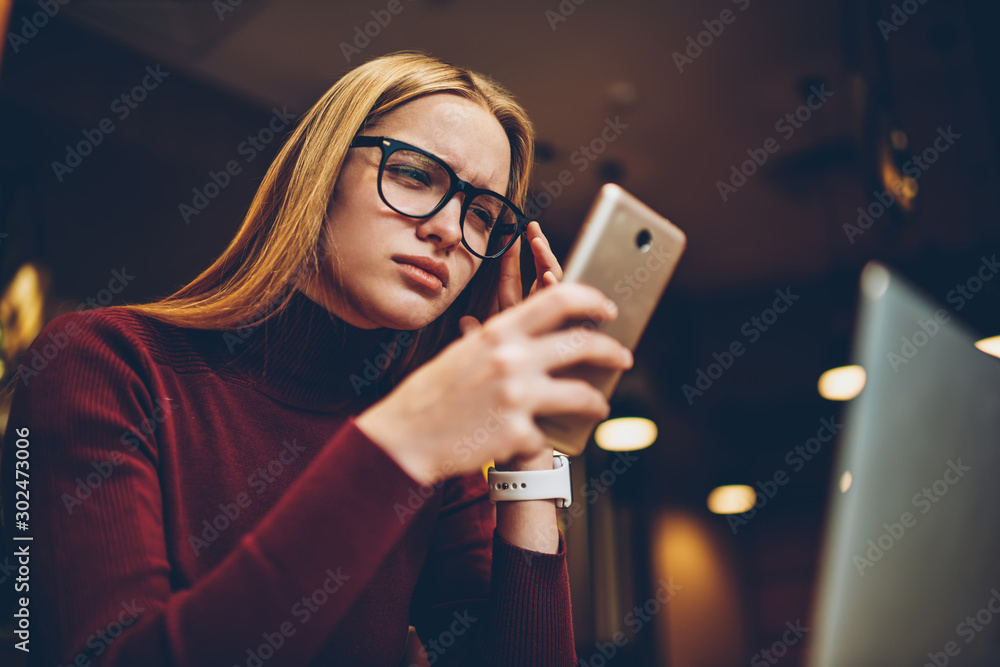 Poster puzzled woman in spectacles for provide eyes protection reading bad news about internet connection v