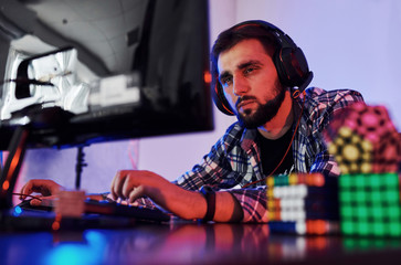 Portrait of young bearded pro gamer playing in online video game © standret