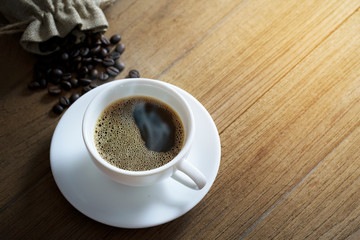white coffee cup and coffee beans on wooden background. Top view.white coffee cup and coffee beans on wooden background. Top view.
