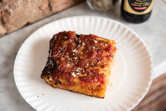 Grandma pizza slice on a paper plate