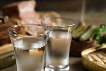 Cold traditional Russian vodka on table, closeup view
