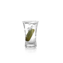Russian vodka with pickle in shot glass isolated on white
