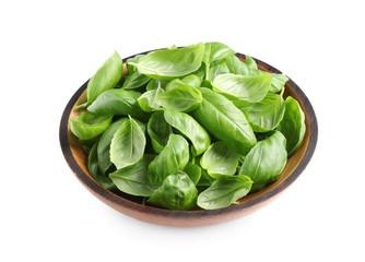 Fresh basil leaves in wooden bowl isolated on white