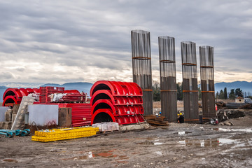 Red panels of round formwork on the construction of the bridge