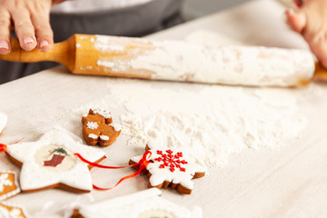 Female hands roll out the dough for Christmas cookies. Close-up.