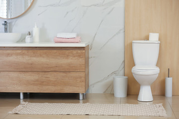 Interior of modern bathroom with toilet bowl