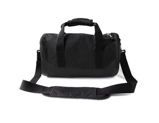 Black duffel bag with handles and shoulder strap. Sports equipment for gym isolated on white...