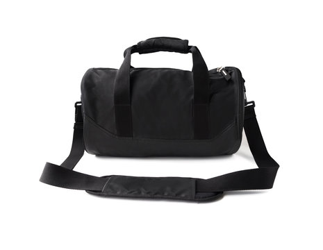 Black duffel bag with handles and shoulder strap. Sports equipment for gym isolated on white background