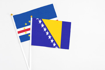 Bosnia Herzegovina and Cape Verde stick flags on white background. High quality fabric, miniature...