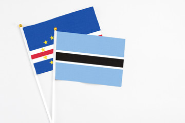 Botswana and Cape Verde stick flags on white background. High quality fabric, miniature national flag. Peaceful global concept.White floor for copy space.