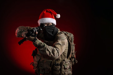 a man in a military uniform with a gun and a Santa Claus hat