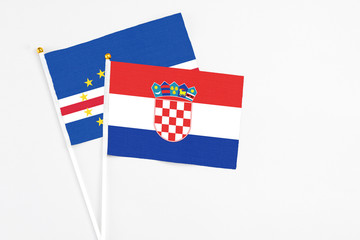 Croatia and Cape Verde stick flags on white background. High quality fabric, miniature national flag. Peaceful global concept.White floor for copy space.