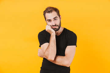 Image of caucasian man in t-shirt propping up his head in boredom