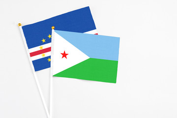 Djibouti and Cape Verde stick flags on white background. High quality fabric, miniature national flag. Peaceful global concept.White floor for copy space.
