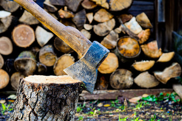 axe on the background of wooden logs, heating season