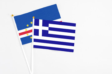 Greece and Cape Verde stick flags on white background. High quality fabric, miniature national flag. Peaceful global concept.White floor for copy space.