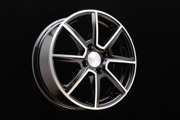 Obraz premium Alloy rim on black background, alloy wheels closeup. The elements spokes