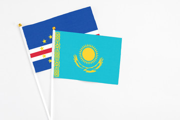 Kazakhstan and Cape Verde stick flags on white background. High quality fabric, miniature national flag. Peaceful global concept.White floor for copy space.