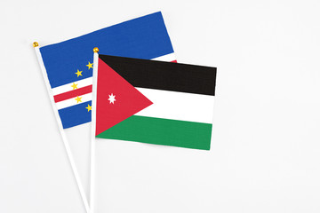 Jordan and Cape Verde stick flags on white background. High quality fabric, miniature national flag. Peaceful global concept.White floor for copy space.
