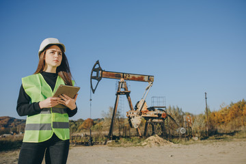 Professional Female Engineer Wearing Safety Uniform and Hard Hat. Engineer Woman Work on Digital Tablet.