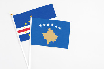 Kosovo and Cape Verde stick flags on white background. High quality fabric, miniature national flag. Peaceful global concept.White floor for copy space.