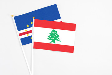 Lebanon and Cape Verde stick flags on white background. High quality fabric, miniature national flag. Peaceful global concept.White floor for copy space.