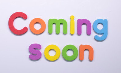"Coming soon" written with color sponge