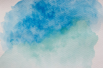 Abstract blue watercolor splash on white background.