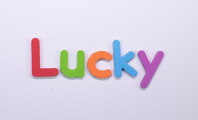 Word Lucky written with color sponge