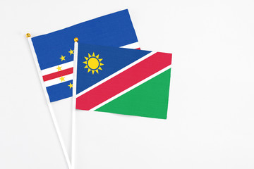 Namibia and Cape Verde stick flags on white background. High quality fabric, miniature national flag. Peaceful global concept.White floor for copy space.