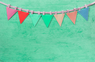 Abstract vintage fabric party flag on green texture background, celebrate and party concept background