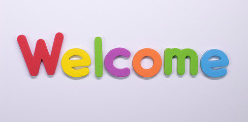 Word Welcome written with color sponge