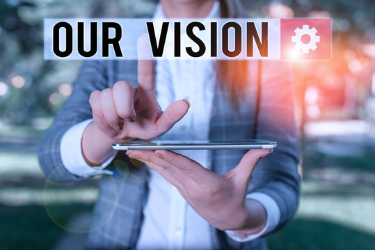 Text sign showing Our Vision. Business photo text serves as clear guide for choosing current and future actions Outdoor scene with business woman holds lap top with touch screen