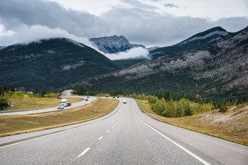 Scenic road trip with rocky mountain in autumn forest at Banff national park