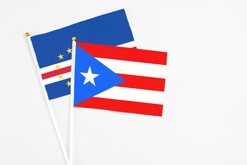 Puerto Rico and Cape Verde stick flags on white background. High quality fabric, miniature national flag. Peaceful global concept.White floor for copy space.
